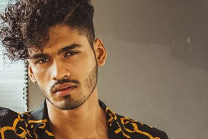 Man with bundled curls with an undercut